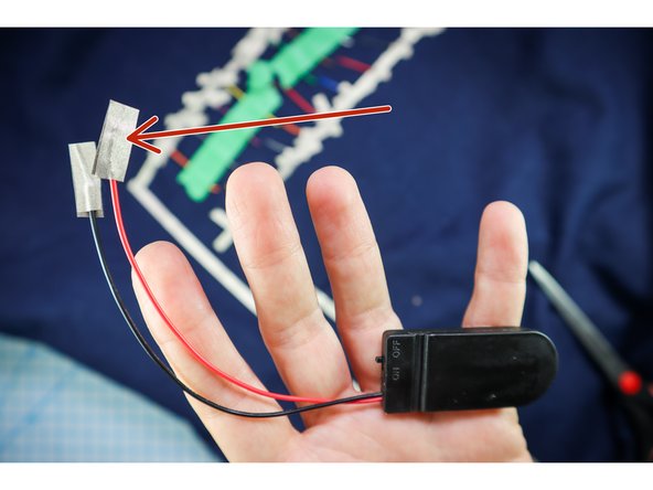Route a long piece of Maker Tape from each line of wires to the battery pack location as shown.