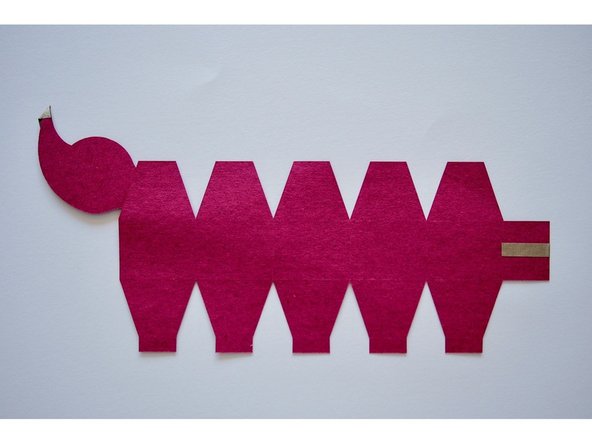 At the very end, fold over about an inch of tape so it overlaps onto the tab on the front side of the tail.