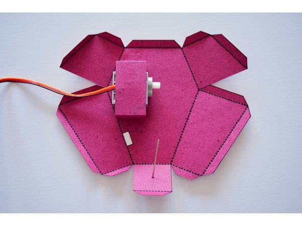 Use a needle to poke a hole through the dot marked on the template.