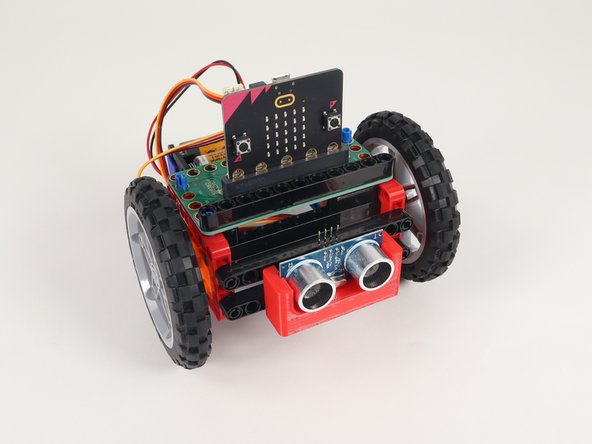 Slide the Distance Sensor Holder with pins into the lower beam on the front of the Rover as shown.