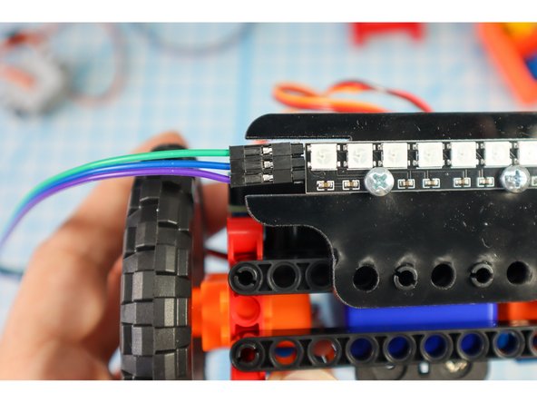 Grab a set of wires and connect three of them to the NeoPixel strip, making note of what color is connected to IN, VCC and GND.