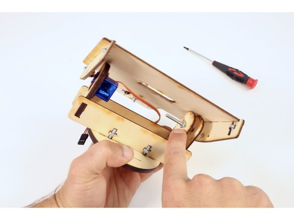 Use one (8-32) nut and your screwdriver to solidify this connection. Don't over tighten! This screw functions mostly as an axle that allows the plate above to swivel.