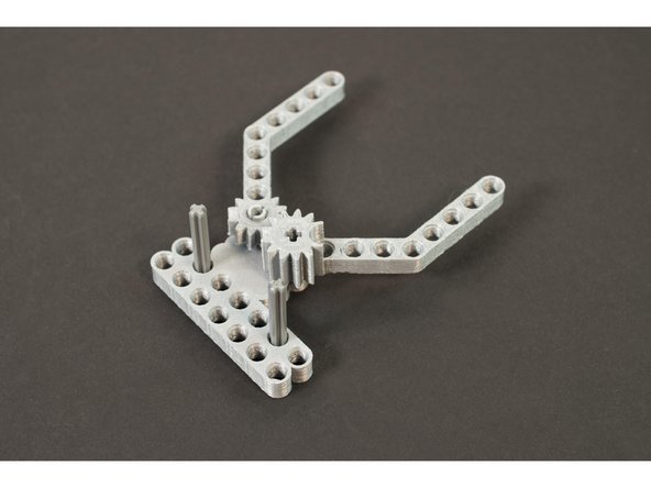 Next we'll add the two LEGO Axle 4 with End Stop (87083) parts into the appropriate holes in the base.