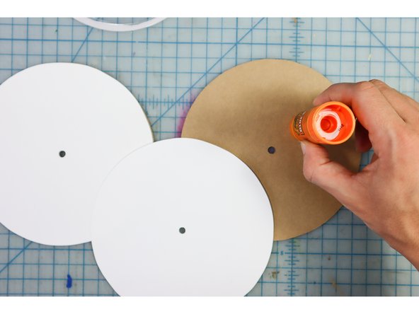 Glue the white cardstock circles to the cardboard circles with a glue stick.