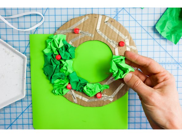 I glued the crumpled rectangles in place all around the wreath, alternating between shades of green.