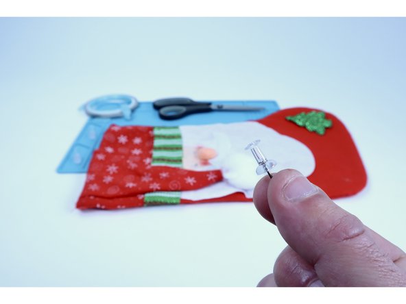 These accents are almost always held on by blobs of hot glue and may have several layers of material below THAT. For these reasons, use a push pin to make to make two &quot;pilot holes&quot;  for each LED (4 TOTAL) through the material along a horizontal row where each accent eyeball was for the LED legs to be threaded through in the next step.