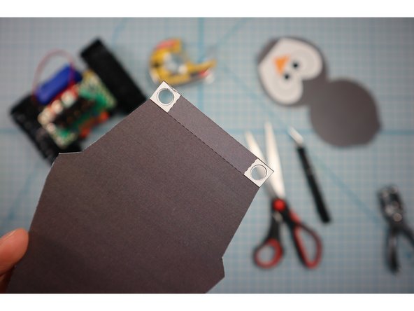 Use a standard hole punch to punch out the circled where shown.