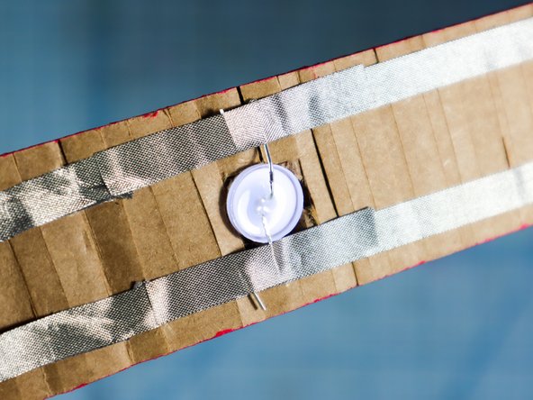 Now, add an extra piece of Maker Tape on top of the LED legs. This should &quot;sandwich&quot; the legs in between two pieces of Maker Tape and the LED should light up!