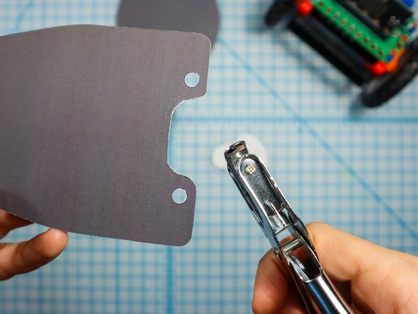 Use a standard hole punch to punch out the circled where shown.