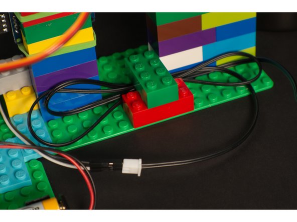 Depending on how you build with LEGO you may have wires running in multiple directions. We just used a few standard bricks to &quot;capture&quot; them and hold them in place.