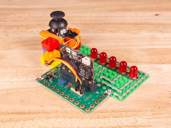 Plug the three-wire connector of the Crazy Circuits Ribbon Cable into the row with Pin 0 on the Bit Board. The wire colors should match the pin header colors, with S1 (yellow) going to the yellow pin.