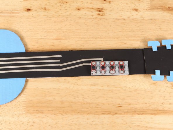 Add a piece of Maker Tape perpendicular to the first path that begins to lead down the neck.