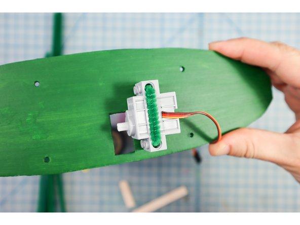 Use a pipe cleaner to attach the motor to the backplate as shown.