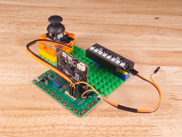 Use the Crazy Circuits Ribbon Cable to connect the NeoPixel Strip to the Bit Board.