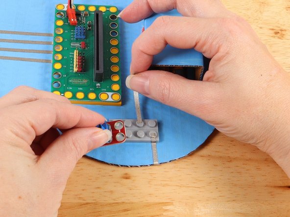 Use a piece of Maker Tape to start a path from the middle hole of the potentiometer closer to the Bit Board as pictured.