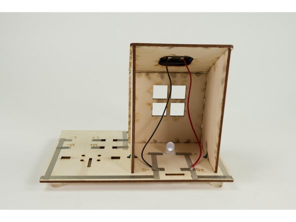 Cut a short piece of Maker Tape and use it to stick down the red (Positive) wire to the spot marked S+.