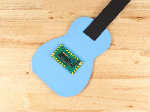 Do NOT get glue on the Bit Board.The LEGO plates are taped in temporarily to help ensure good placement once they are attached, but the Bit Board should be easily removed as needed.