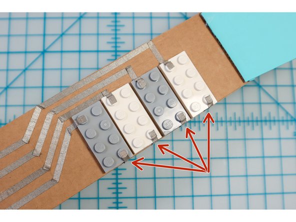 Add 4 ground connections to each LEGO and connect them on the back of the neck as shown.