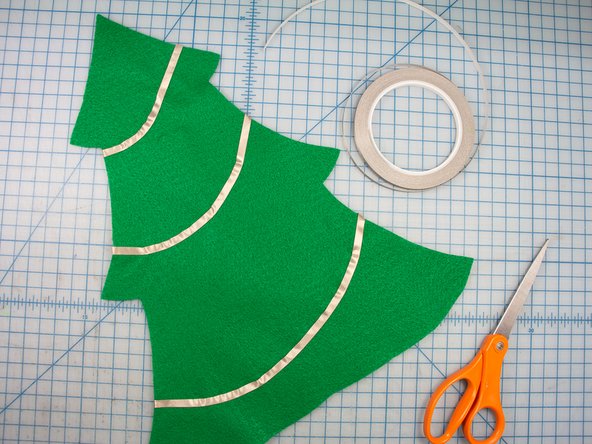 Slowly &quot;draw&quot; the garland around the tree in one continuous piece, peeling the backing off of the tape slowly as you go.