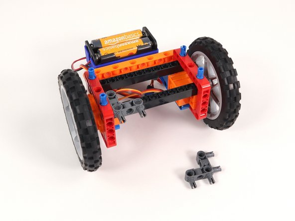 Add two gray 90° connectors to the Rover as shown. One side should connect to the inside of a red frame and the other pins should stick out towards the front of the Rover.