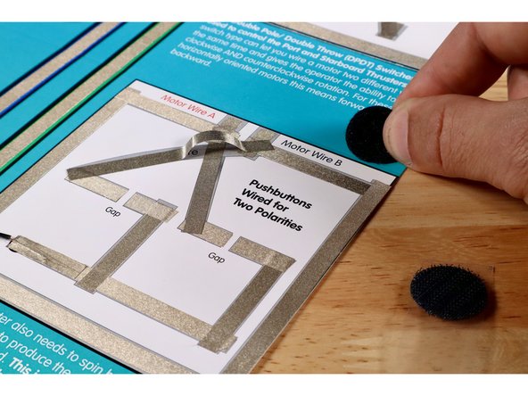 Peel and stick the remaining fuzzy half of your remaining hook and loop dots onto the circle labeled &quot;motor&quot;.