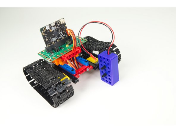 The battery holder will attach to the top frame piece sideways, as shown.