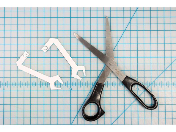 Tip: You don't need to punch the holes unless you plan to create the moving arms. To learn how to do this, follow this tutorial.