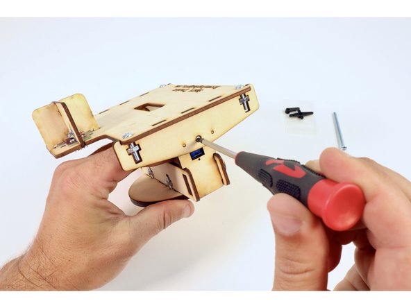 Use the screwdriver to tighten that small screw to the servo axle that you inserted into the horn. This single screw will  join this side of these two subassemblies.