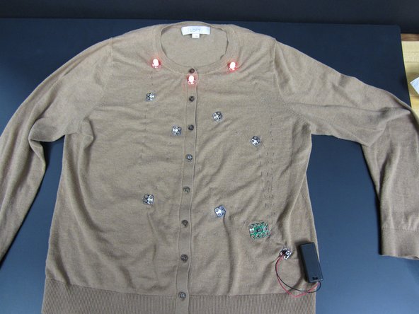 Use Conductive Thread to connect the Positive Sides of your LEDs to the pins on the Blink/ Fade Board.