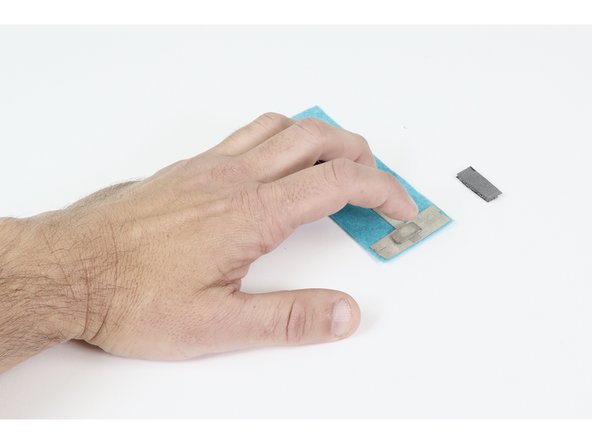 Press that tape loop into contact with the center of one of the two widened ends of whichever circuit you are working on. NOTE: What is pictured is NOT a working circuit. It is only a mock up of the portion relevant to this process.