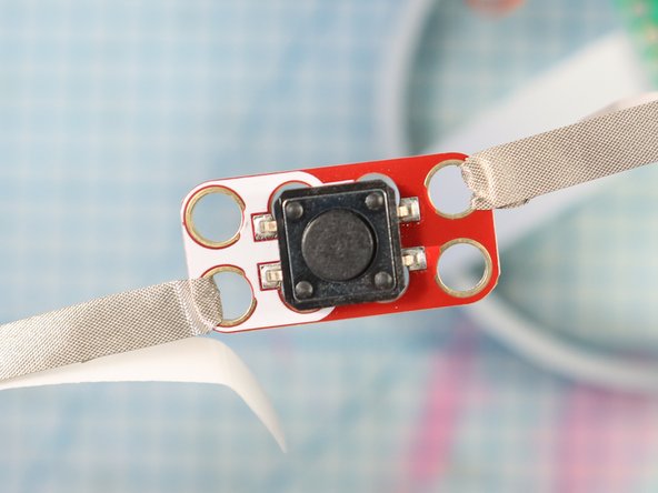 Wrap Maker Tape around the button, connecting it to itself as shown.
