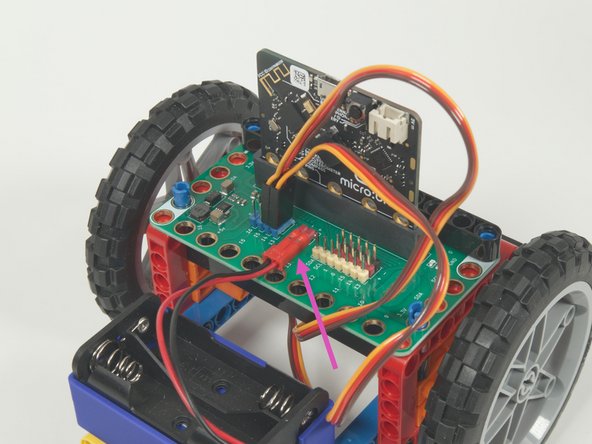 The last connection is the battery pack. It connects to the Bit Board as shown to provide power to the micro:bit and the servos so your rover can move.