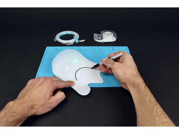 Use a marker to draw an expressive mouth on the vellum  and them a craft knife to cut it from end to end. This should allow you to pull the mouth away from the rest of the shape a bit as pictured in photo 3.