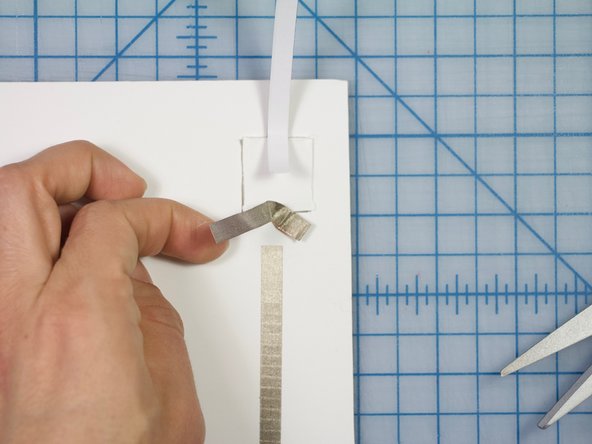 Attach one of the strips of Maker Tape to the line of Maker Tape coming from the LED.