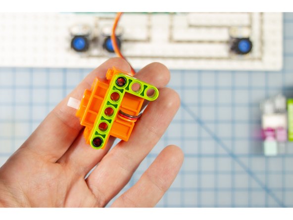 Stack a tower of bricks and connect the beam to the top of it.