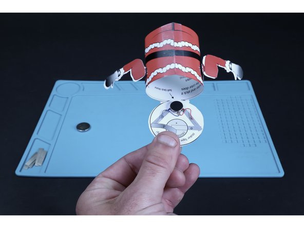 Peel and stick the vibrating motor in place where shown on the circuit diagram.