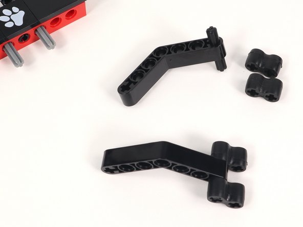 Attach a rubber gripper to each end of the axle on both grippers as pictured. These can be adjusted when using depending on what you are trying to grab.