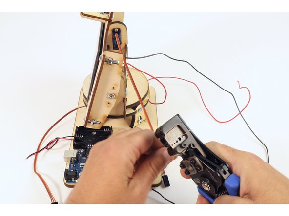 Using a wire stripper, remove about 1/4" of insulation from each of the three wires that are connected to the voltmeter.
