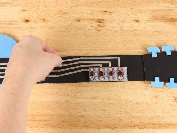 Add a piece of Maker Tape perpendicular to the first path that begins to lead down the neck.