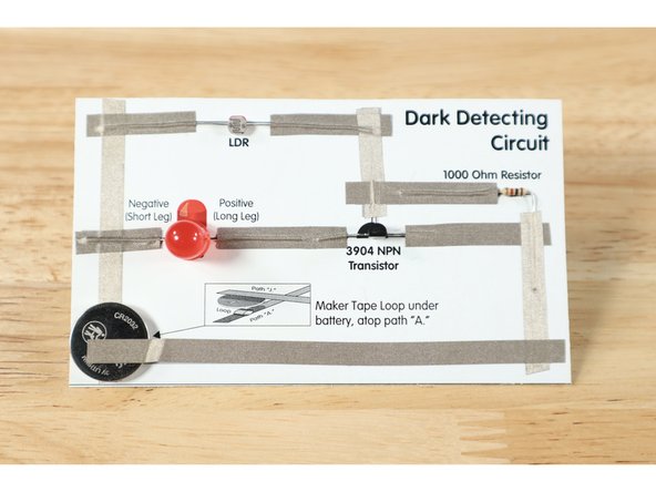 If you have assembled your circuit in the light, the LED should NOT be lit. When you cover the LDR or even cast a shadow over it, the LED should turn on.