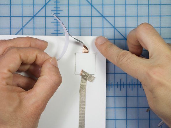 Direct the second piece toward the LED and adhere it to the poster board.