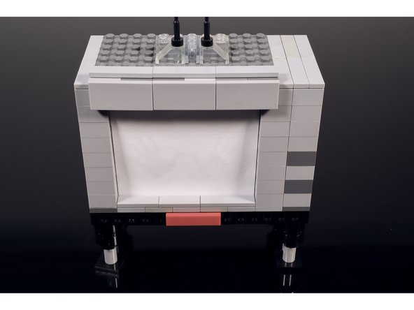 Add some tiles to seal the deal (we used some 2x2 90 degree plates with flat tiles on them) OR make the walls one layer shorter so there is no gap between the top of the TV build and the top of the shadowbox.