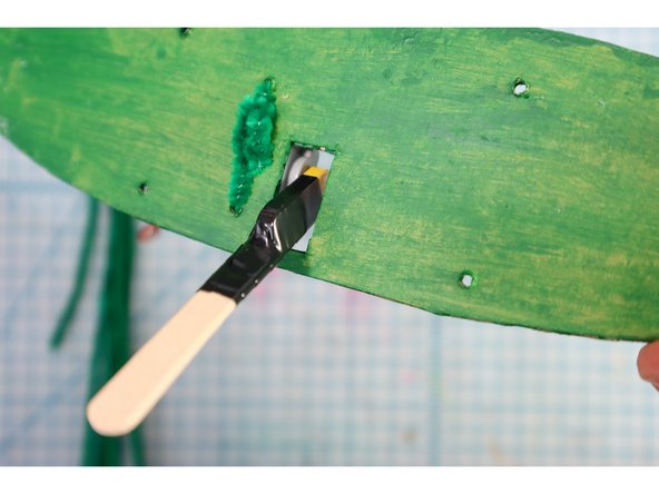 Connect the stick to the motor, placing it through the hole as shown.