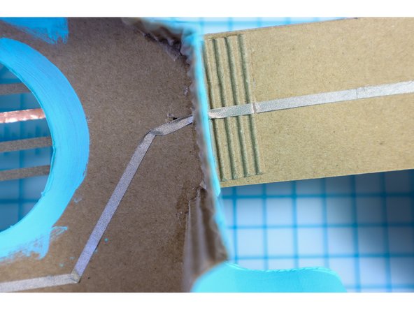 Continue the ground connection down the back of the neck to the Bit Board by placing a hole in the wall as shown.