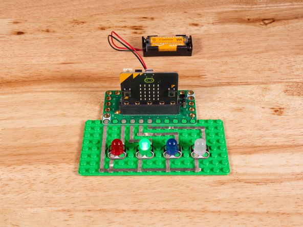 Connect the Negative (-) sides of the LEDs to a Ground (GND) hole on the Bit Board.
