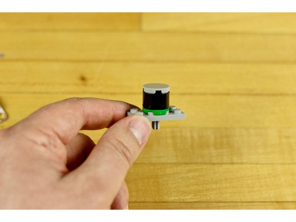 Use the 2x2 round tile with the hole in it and place it on top of the hole you wish to use on the plate.