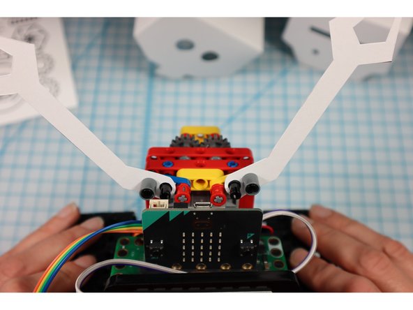 Disconnect the pins and place the arms onto the half beams. Then, replace the pins.