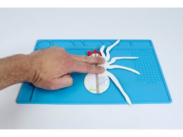 Choose the corresponding leg template and press it into place as shown so the smallest legs are oriented toward the LEDs.