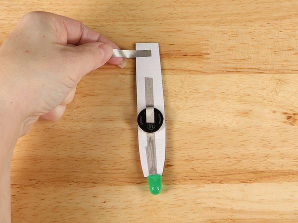 Add a piece of Maker Tape that starts on the back of the handle and wraps around to the front of the handle.