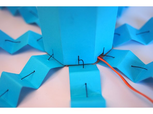 The thread should slide into the thin cutouts in the body